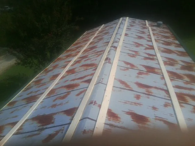 Rusted metal roof panels with new wood purlins before replacement — Storm Damage Roof Repair in Chualar by Roofing Brothers